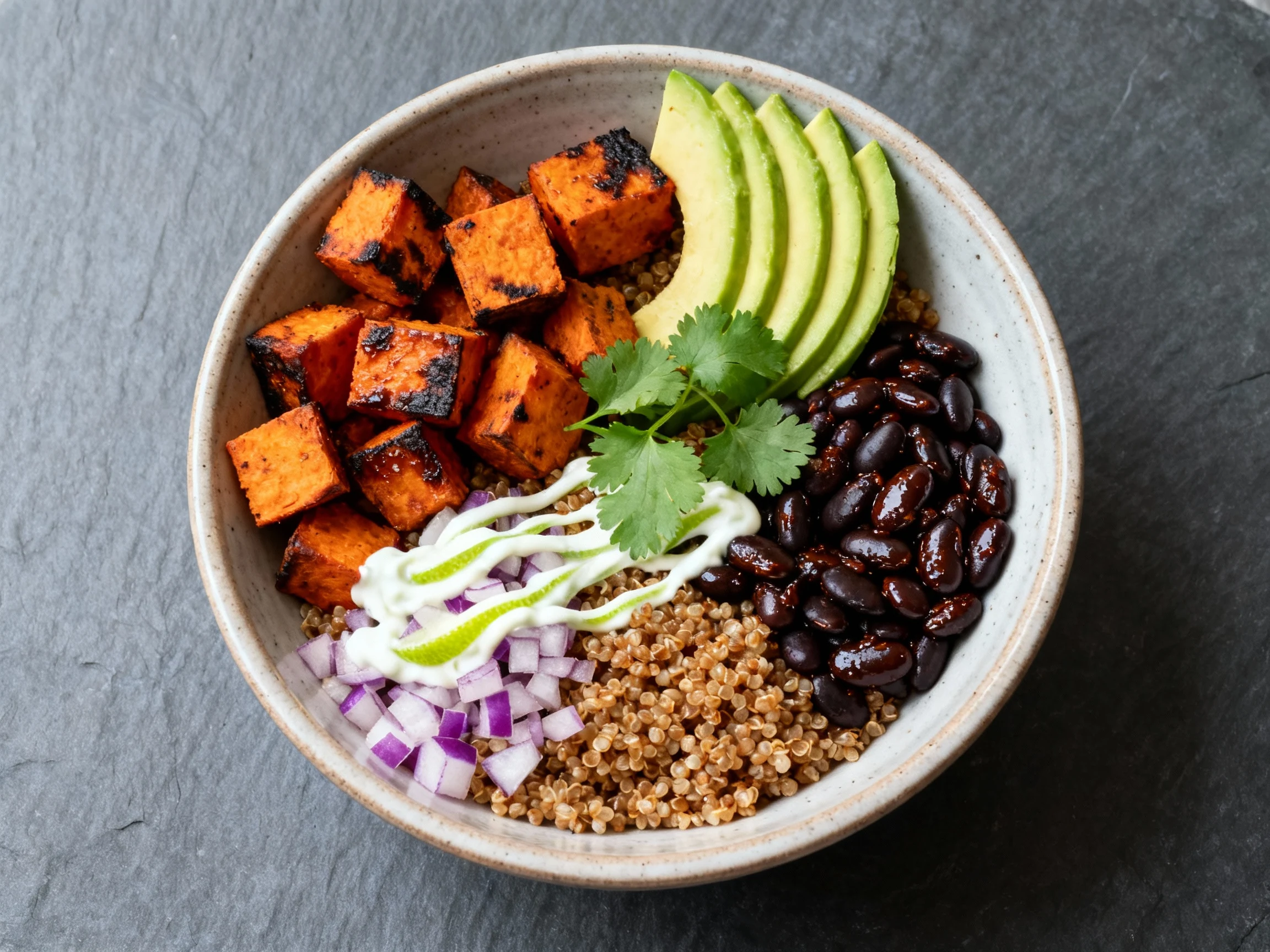 Food photography, Close-up of Smoky Chipotle Black Bean & Roasted Sweet Potato Bowl: charred sweet potato cubes and glos