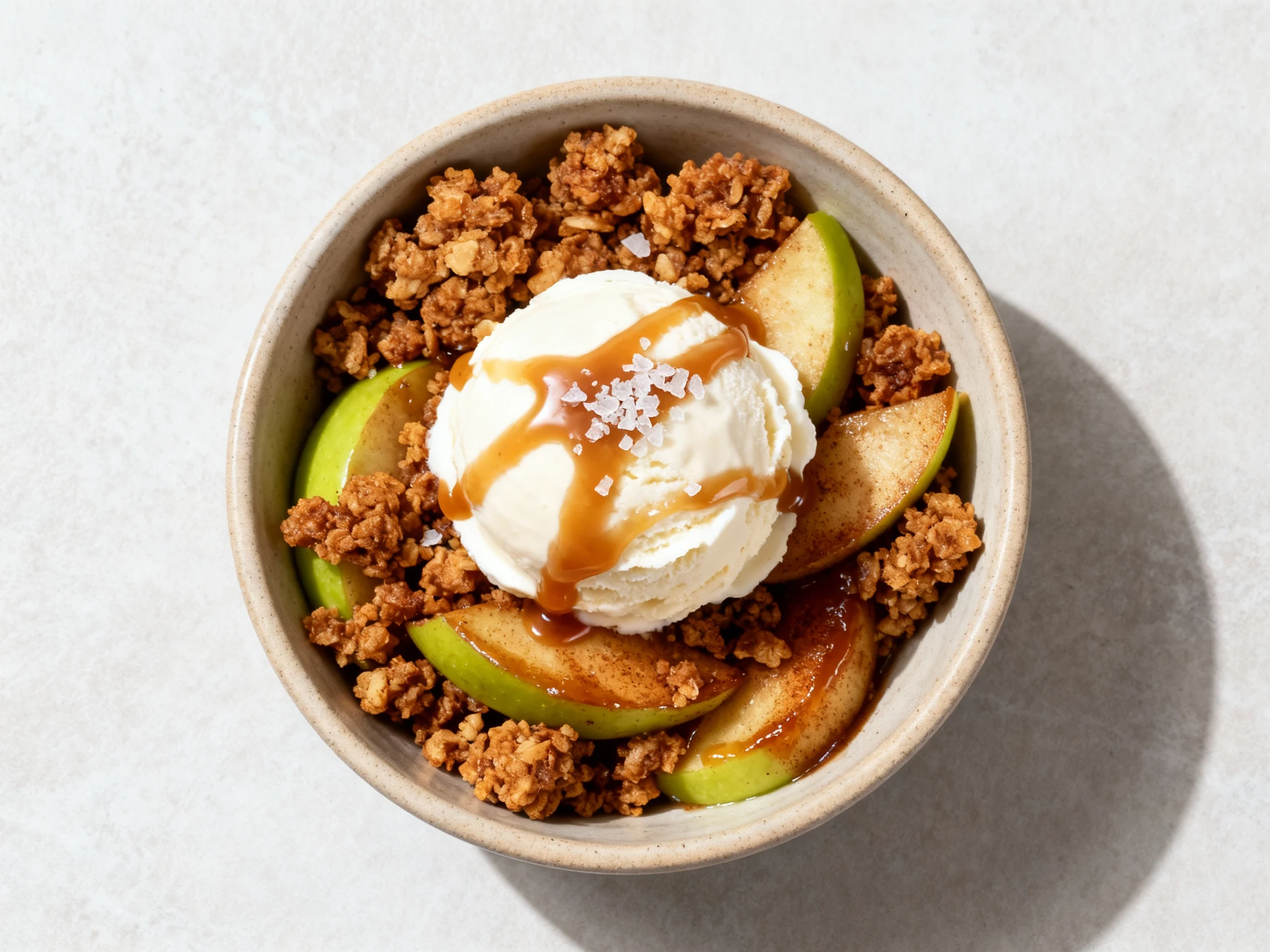 Food photography, Overhead shot of the final plated green apple crumble: a warm scoop in a shallow ceramic bowl topped w