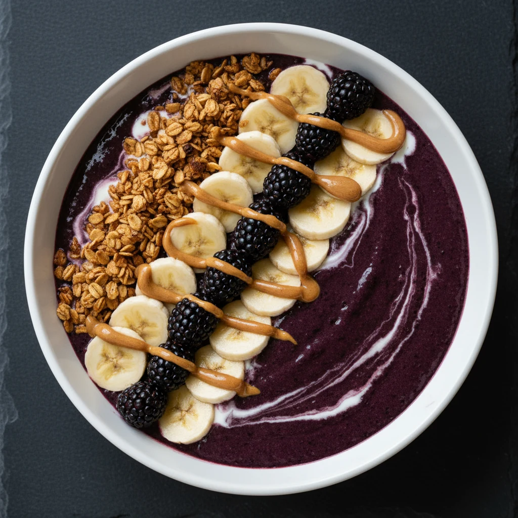 Food photography, Overhead top view: thick blackberry smoothie bowl (breakfast bowl) with a velvety, jammy purple base a
