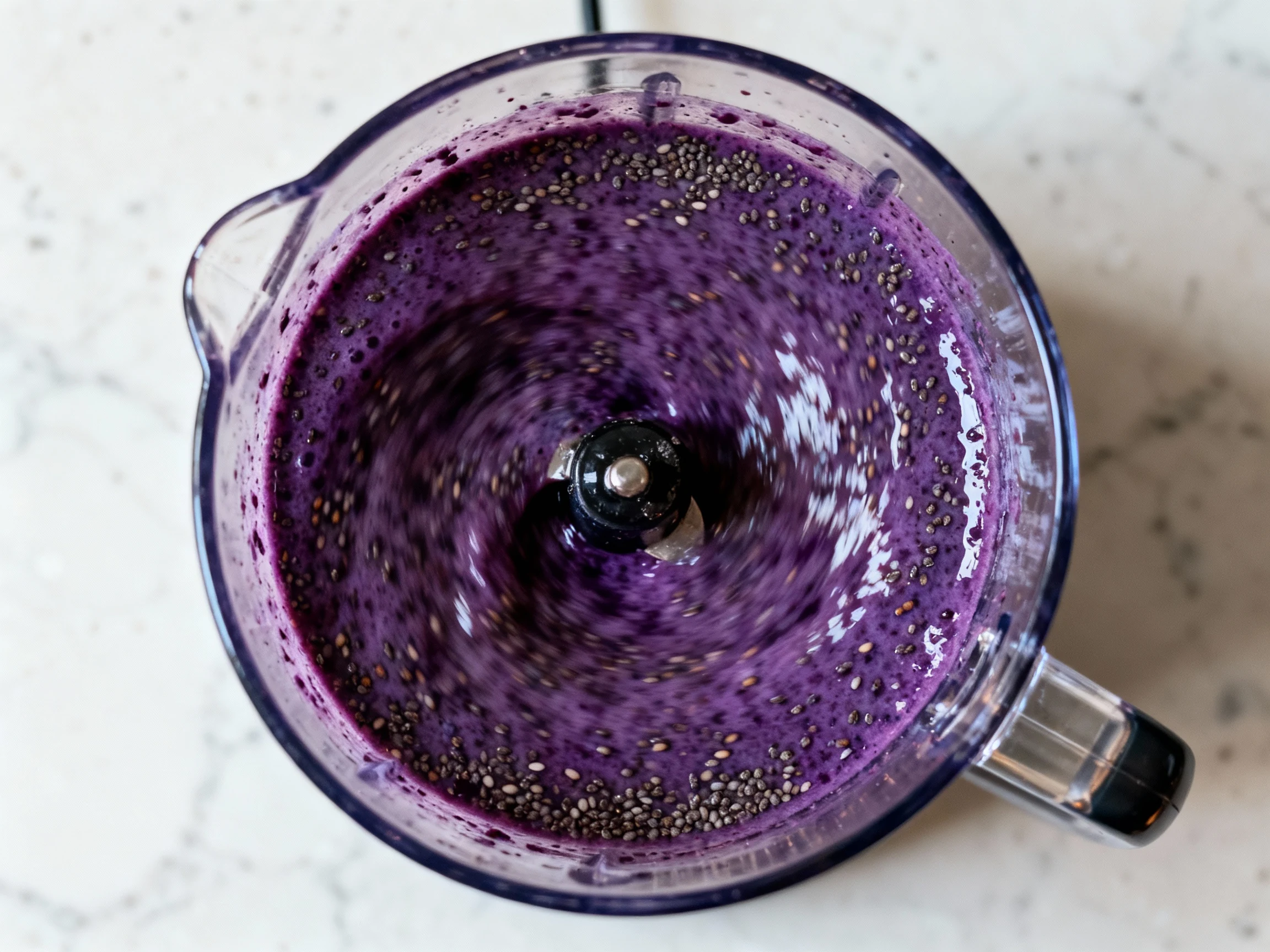 Food photography, Cooking process: overhead look into a high-speed blender during the final blitz of a berry-based high-