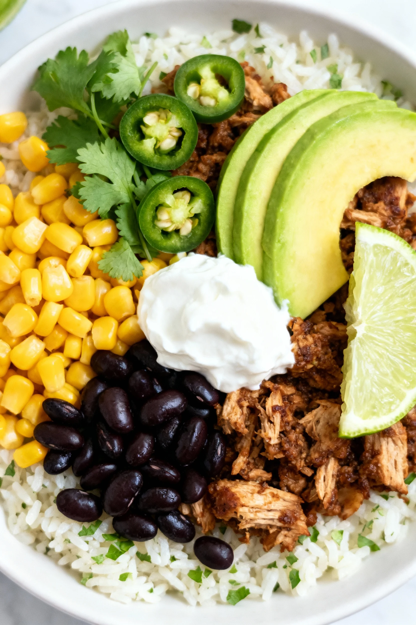 Overhead shot of Chipotle-Lime Turkey Taco Bowl: cilantro-lime rice base topped with browned spiced turkey, sweet corn k