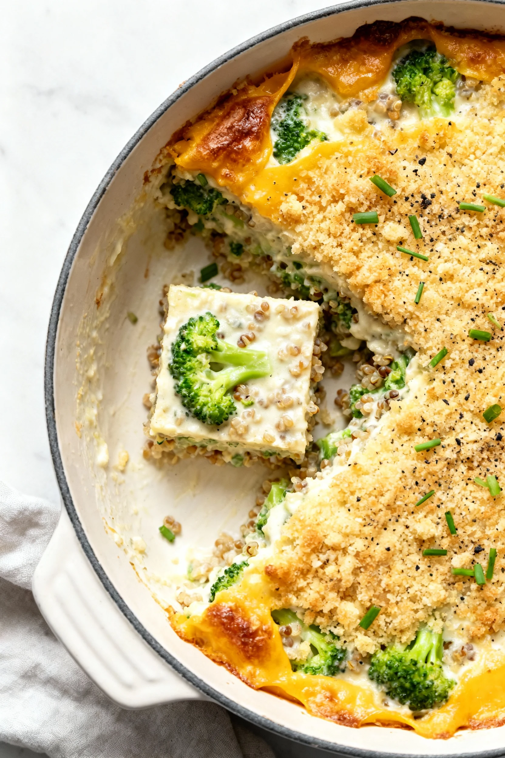 Food photography, Overhead shot of the baked casserole in a 2-3 qt dish with one square removed; creamy interior with br