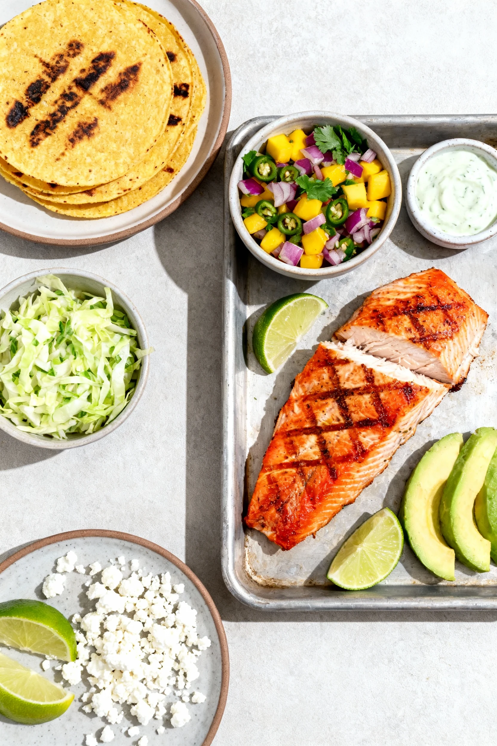 Food photography, Overhead shot of taco assembly: warm charred corn tortillas, tray of flaky grilled red snapper, bowl o