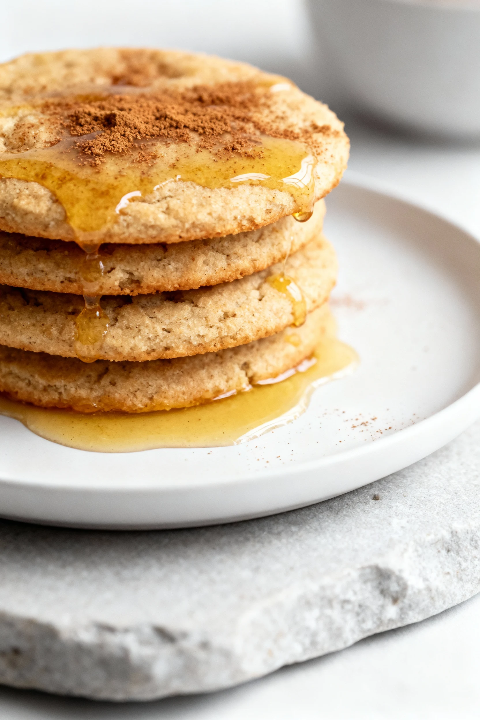 Food photography, Beautifully plated cinnamon-honey coconut flour biscuits: warm stack with a glossy ghee sheen, delicat