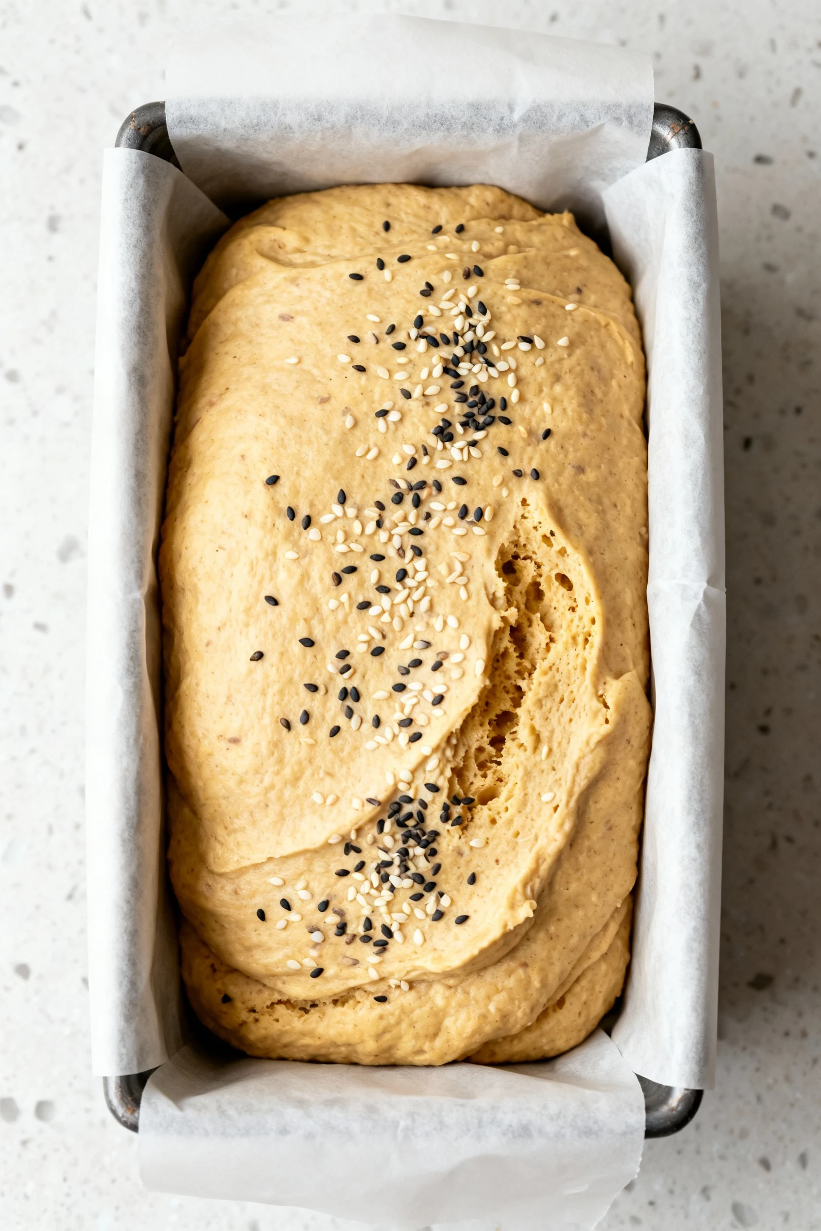 Food photography, Cooking process: thick, hydrated batter smoothed and slightly domed in a parchment-lined 8.5 x 4.5 in 