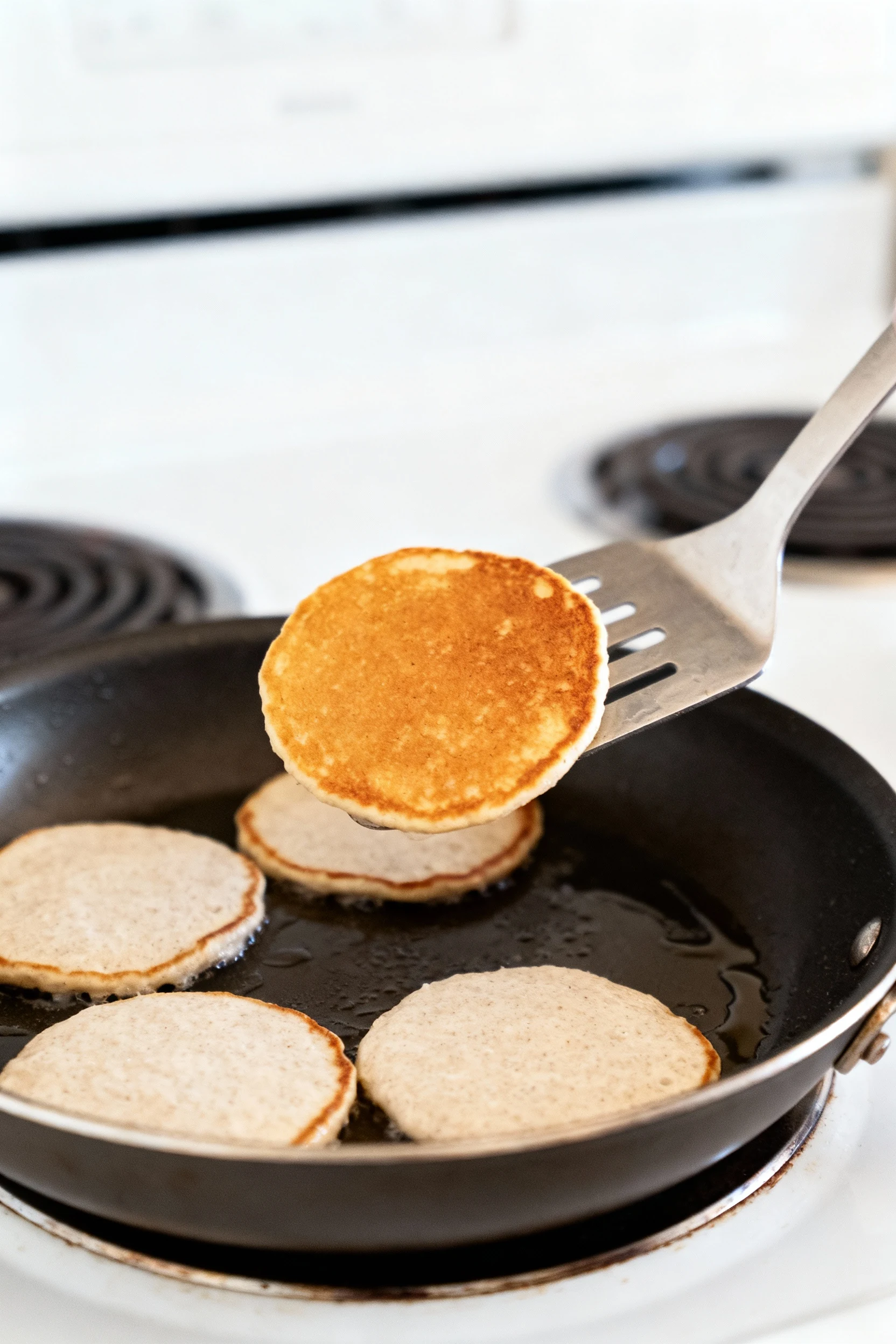 Cooking process: coconut flour pancakes in a lightly oiled nonstick skillet over medium, 1/4-cup rounds with set edges, 