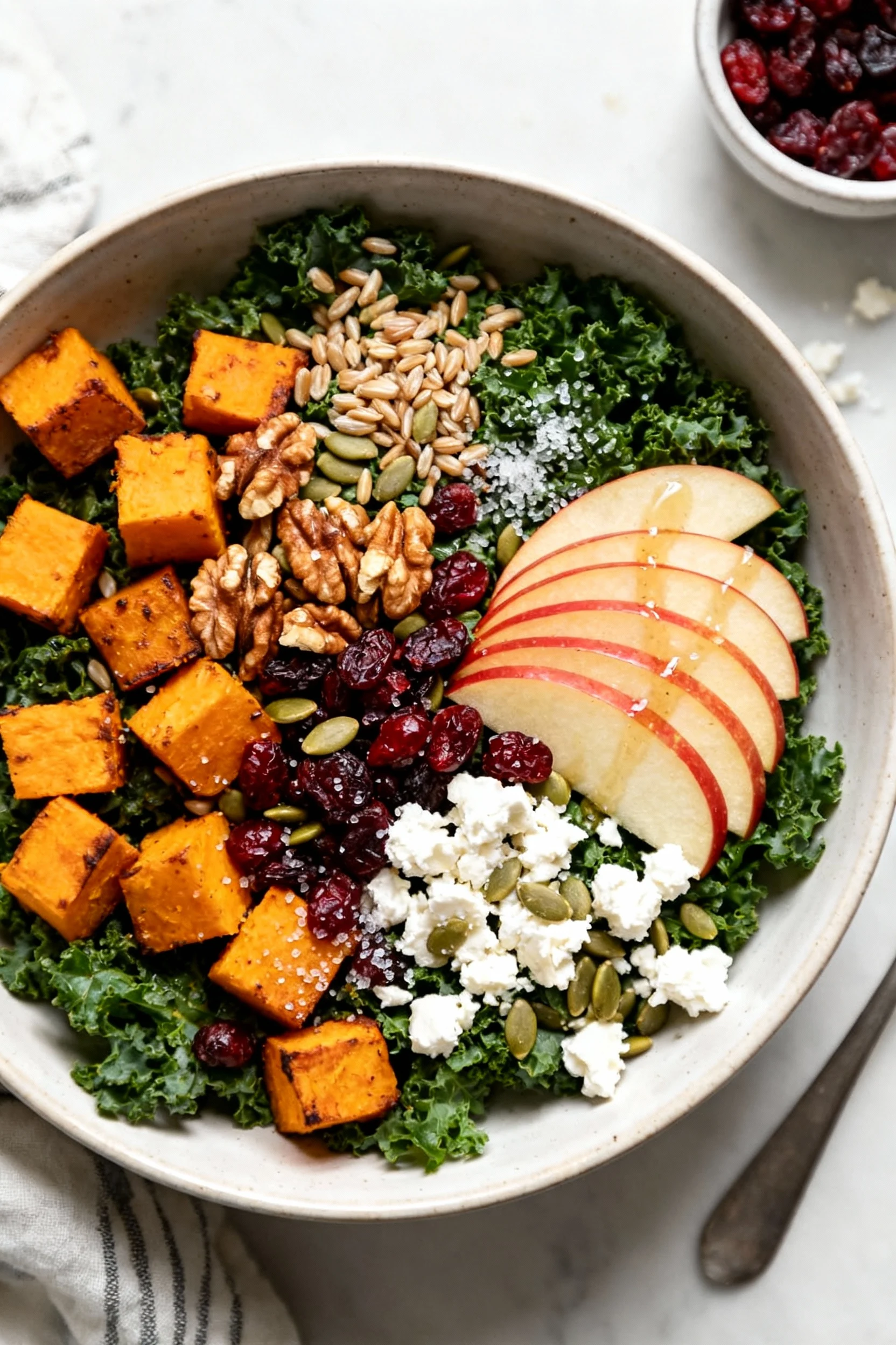 Tasty top view: overhead shot of the assembled fall salad in a wide, shallow bowl—kale base, roasted squash, fanned Hone