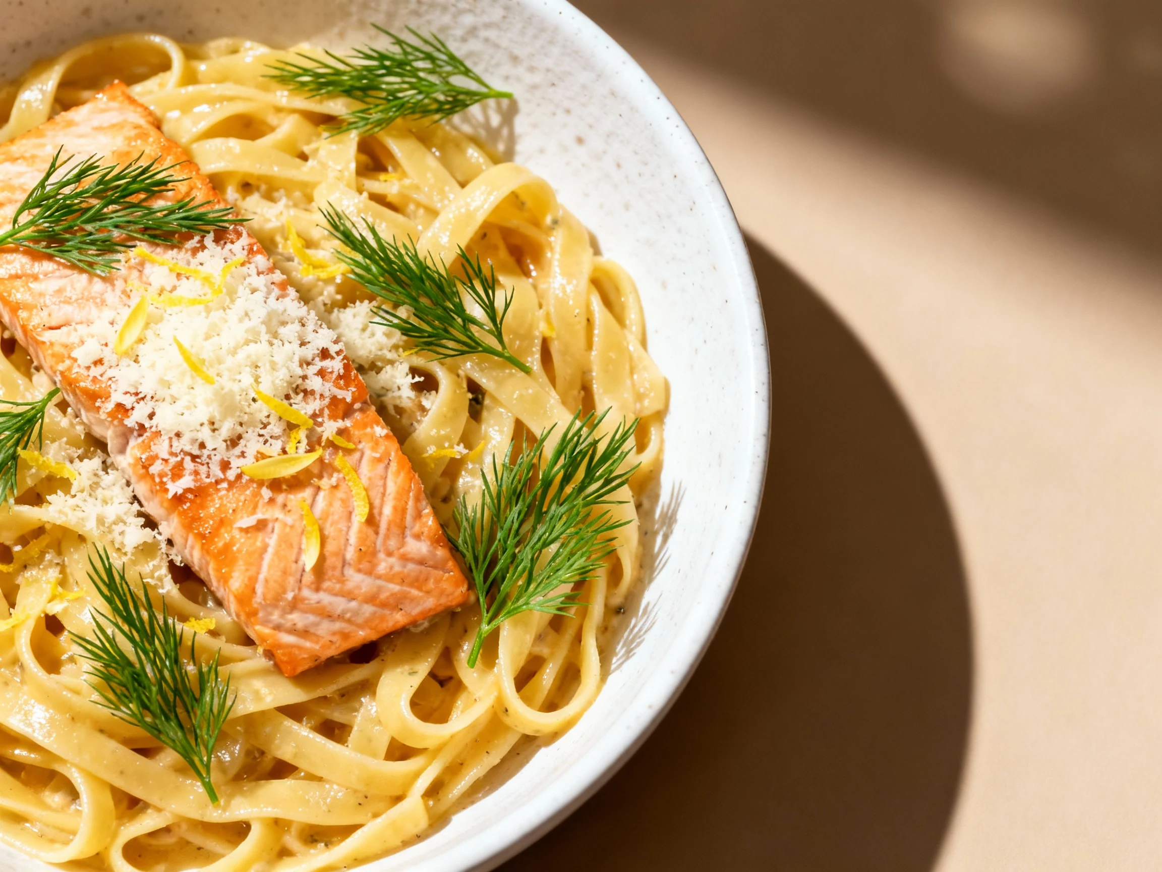 Food photography, Overhead shot of a finished salmon pasta dish in a white ceramic bowl, garnished with bright green dil
