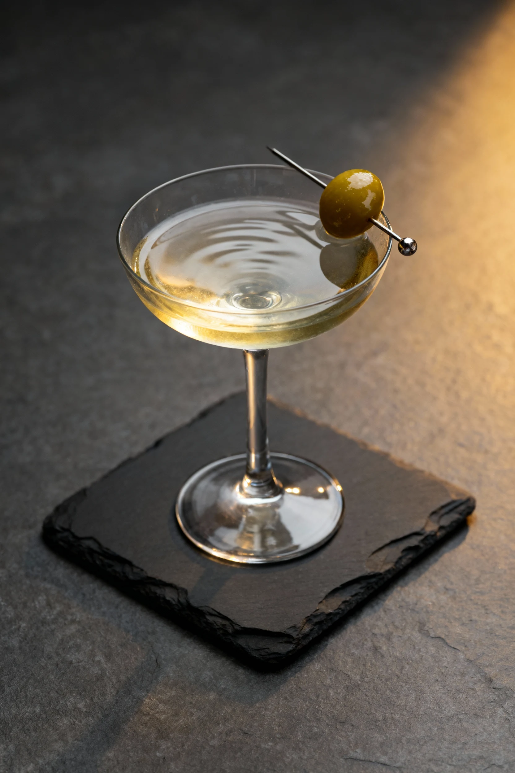 Beautifully plated Gibson martini with a pickled pearl onion garnish, soft reflections on the surface of the drink, posi