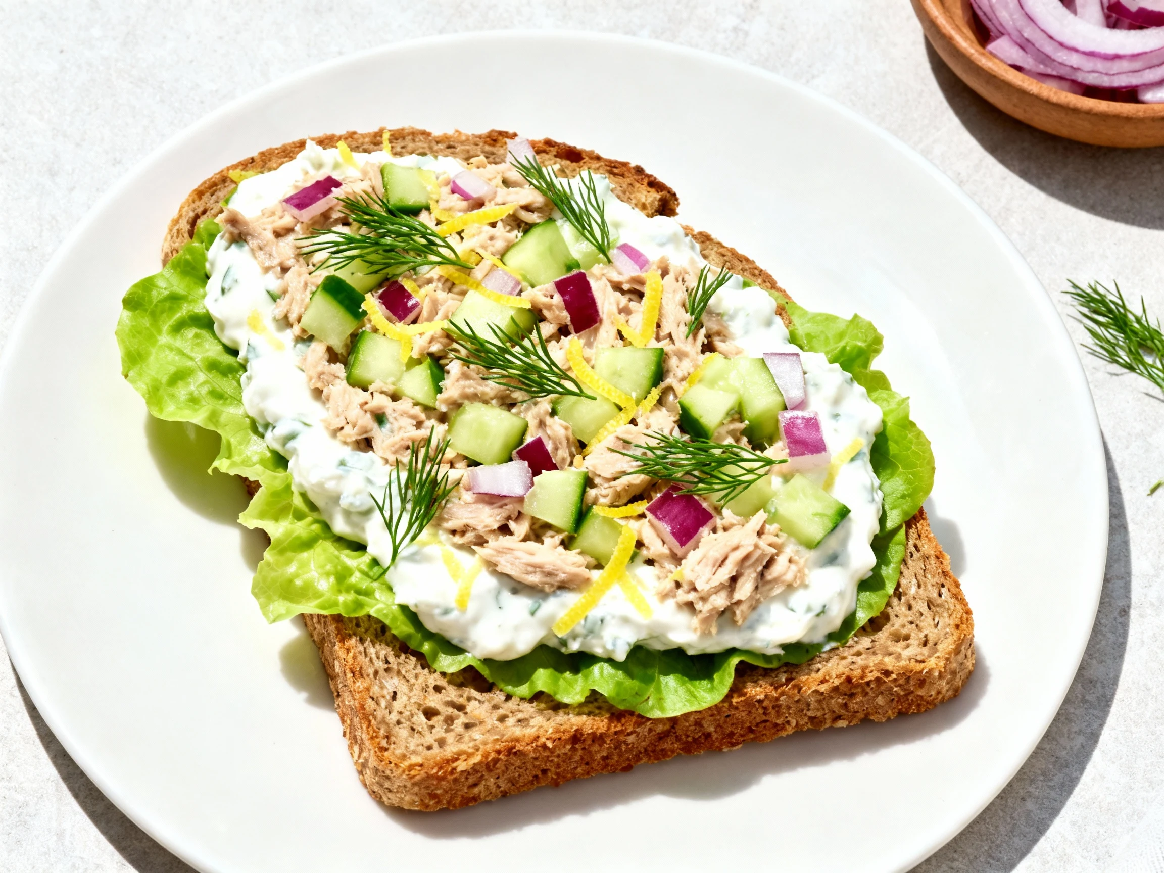 Food photography, Tasty top view of a no-mayo Greek tuna open-face on whole-grain toast: creamy Greek yogurt base with l