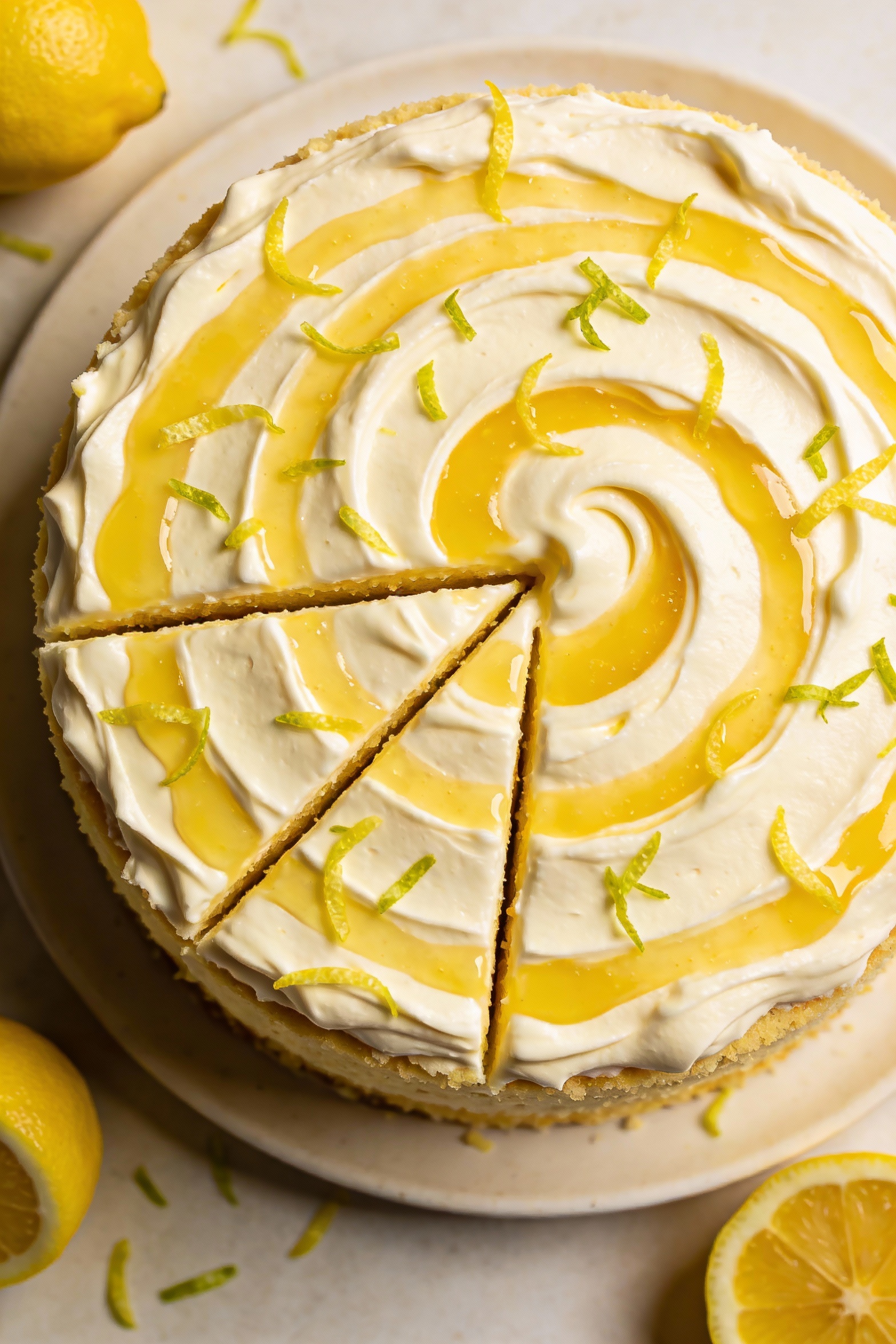 Overhead shot of lemon velvet variation: frosted round cake with cream cheese frosting, visible lemon curd swirl marbled